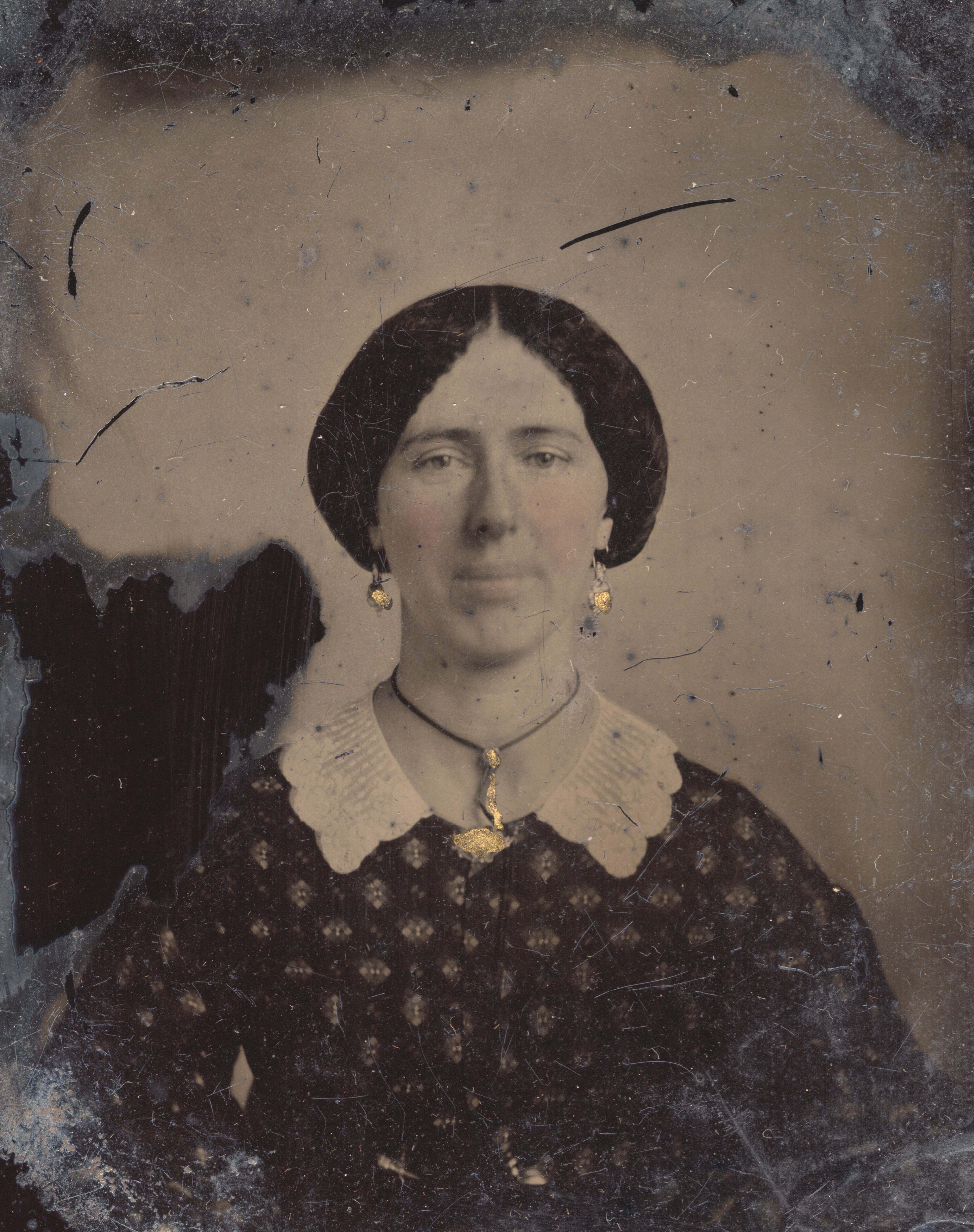 Woman with gold earrings and necklace Woman with gold earrings and necklace